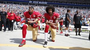 Colin Kaepernick and Jim Brown kneel during the National Anthem