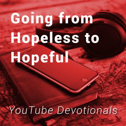 Bible, smart phone, headphones on table with text Going from Hopeless to Hopeful YouTube Devotionals