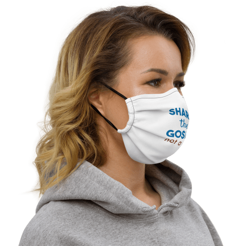 Woman wearing white face mask with black stitching with Share the gospel not a virus