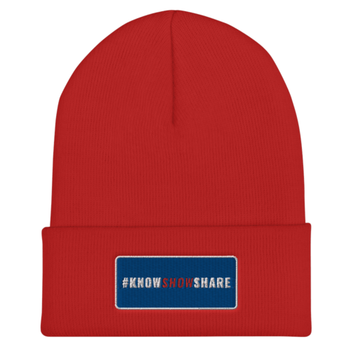 Red cuffed beanie with hashtag Know Show Share inside a blue rectangle with white border
